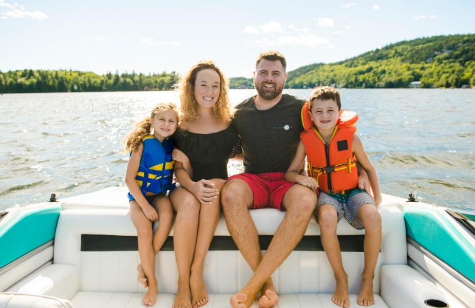 family sitting on a boat